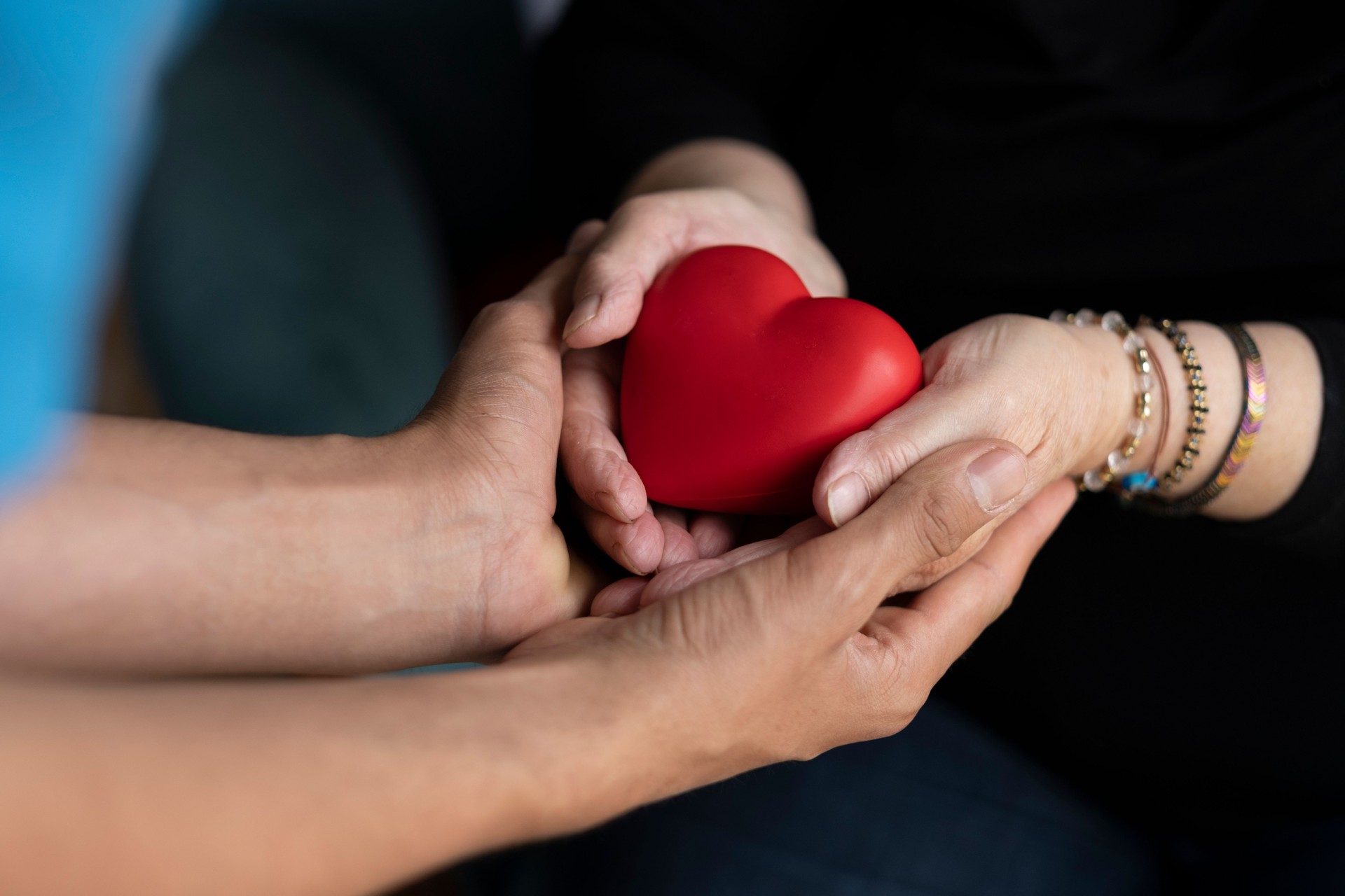 two hands holding heart shape together